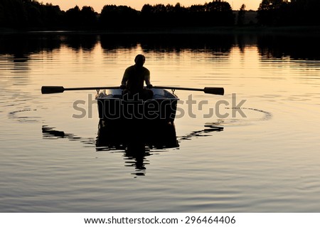 Man with paddles in the boat