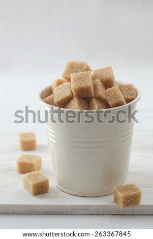 Brown sugar cubes in small metal bucket