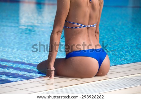 Girl with beautiful back and bum on swimming pool