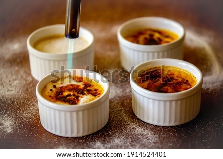 Similar – Image, Stock Photo Creme brulee with caramel crust. Burning sugar on burnt cream