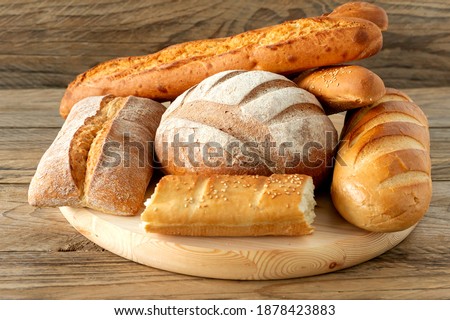 Types of homemade bread on the rustic wooden table. Homemade baked pastry