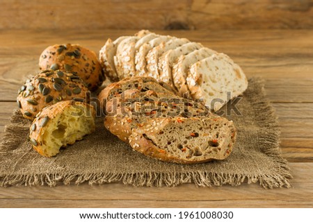 Assortment of Homemade Gluten-free vegan bread on the rustic wooden table. Homemade baked pastry.