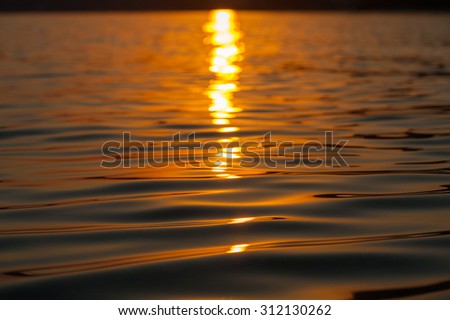 Blurred sunset at sea level, calm sea