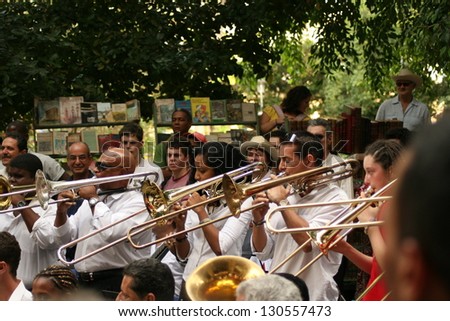 HAVANA, CUBA - JAN 22: Orchestra is playing for tourists on the street on January 22, 2008 in Havana, Cuba.The Cuban music is an attraction for more than 2 million people who visit Cuba every year