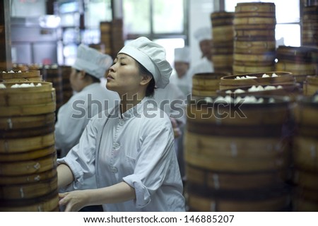 SHANGHAI, CHINA-MAY 4: Ches are cooking dumplings by the traditional bamboo steamers in a restaurant. May 4, 2007 Shanghai, China. The Shanghaiese dumpling is one of the most famous food in China.