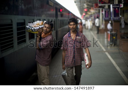MUMBAI, INDIA - AUG 10: Staffs from station restaurant are serving breakfast to the commuter on train on August 10 2012, Mumbai, India.