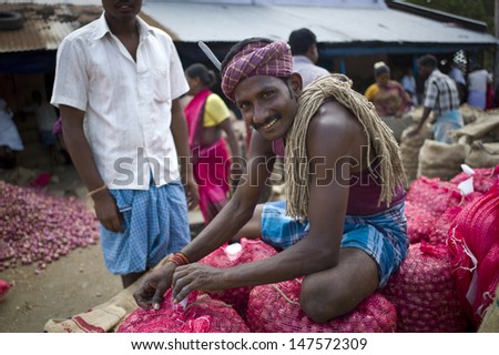 TRICHY, INDIA - AUG 3: Unidentified people segregate onion on August 3, 2012 in Trichy, India. Amongst the onion producing countries in the world India ranks second in area and production.