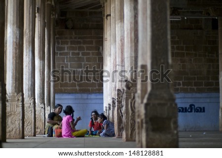 MADURAI, INDIA - AUG 6: Pilgrims rest inside Meenakshi Temple on August 6 ,2013 in Madurai, India. The temple is one of the holiest in South India.People walk miles to pray.