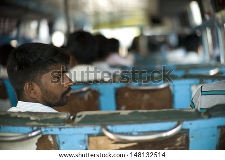 THANJAVUR, INDIA - AUG 14: unidentified Indian is sitting on a very old bus August14, 2012 in Thanjavur, India. The bus in India has been so outdated due to inadequate budget.