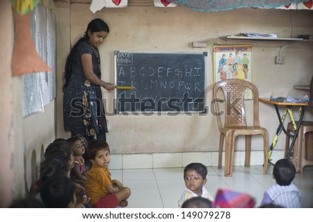 MUMBAI, INDIA - NOV 5: Unidentified children learn at a small classroom in the slum Dharavi on November 5, 2012 in Mumbai, India. Dharavi is the biggest slum in the world.
