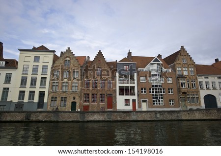 BRUGES, BELGIUM - NOV 30: Houses along the canals of Brugge or Bruges, Belgium on November 20, 2012. Bruges is frequently referred to as 