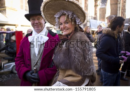 HAARLEM, NETHERLANDS - DEC 9: People dress like those in the past to celebrate Christmas in the Christmas flea market, on December 9 2012 in Haarlem, Netherlands. Haarlem is a historical city.
