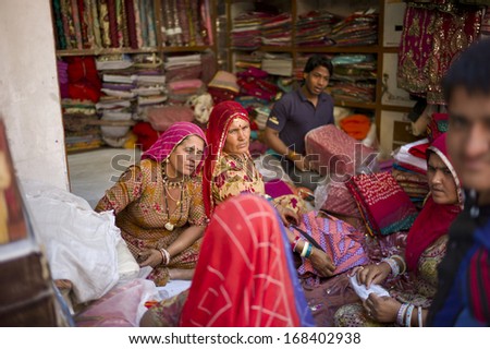 JODHPUR, INDIA - FEB 1: A group of unidentified women in colorful attire is shopping in the market on February 1, 2013 in Jodhpur, India. The clothes of Rajasthan woman are famous for the color.