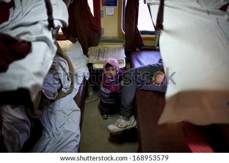 JODHPUR, INDIA - JAN 23: Unidentified child is taking 2A sleeper class on the long-haul train to Jaisalmer on January 23,2013 in Jodhpur, India. 2A class is a relatively clean class in India.