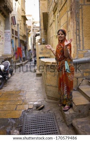 JAISALMER, INDIA - JAN 12: Unidentified Indian woman lives in Jaisalmer Fort in Thar desert on January 12, 2013 in Jaisalmer, India. Jaisalmer Fort is the only livable fort in India.