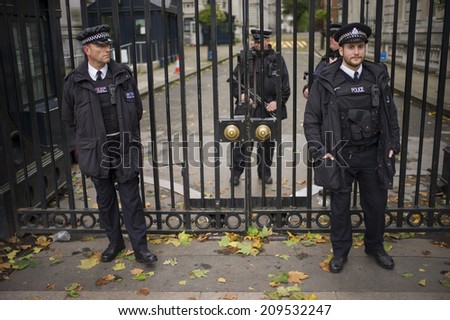 LONDON, UK - NOV6: Police officers guard the door of 10 Downing Street in London, UK on November 6, 2013. British PM David Cameron is working and living in the premise.
