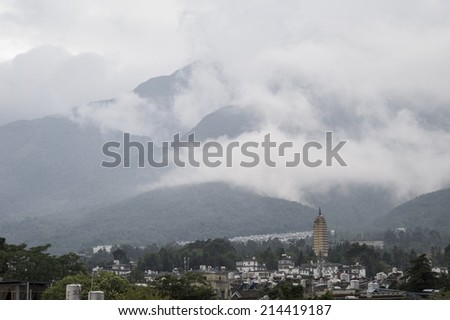 DALI, CHINA - MAY14 : pagoda and mountains on a cloudy day in Dali Old City, Yunnan, China on May 14 2014. Dali is now a major tourist destination for domestic and international tourists.
