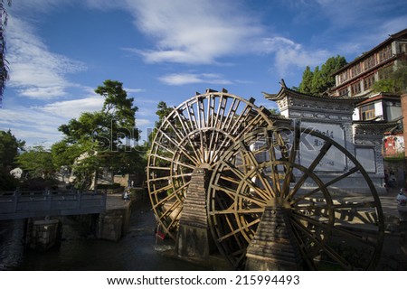 LIJIAN, CHINA - MAY 16: The old watermill at the entrance gate in the famous LiJian Old City, China on May 16 2014. Lijian is one of the biggest and well-preserved old town in China.