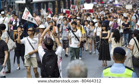 HONG KONG, CHINA - JULY 1: People going to protest for the government policy in Hong Kong on the anniversary of Handover Day on July 1, 2011 in Hong Kong, China.