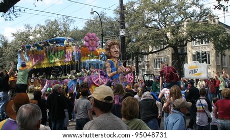 NEW ORLEANS - FEBRUARY 2: People on the float threw doubloons and beads to the crowd in Mardi Gras parade. February 2, 2008 in New Orleans, Louisiana.