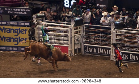 NEW YORK - JAN 10: An unidentified bull rider tries to stay on the bull for 8 seconds during the Professional Bull Rider tournament on January 10, 2009 in New York, NY.