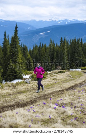 Female running athlete. Woman trail runner sprinting for success goals and healthy lifestyle in amazing nature landscape.