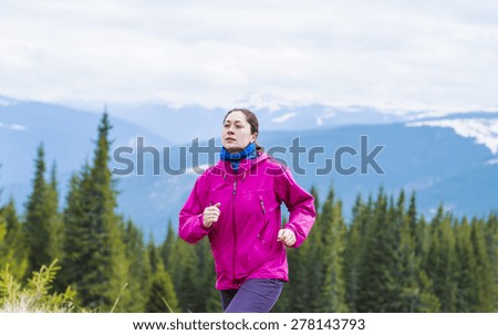 Female running athlete. Woman trail runner sprinting for success goals and healthy lifestyle in amazing nature landscape.