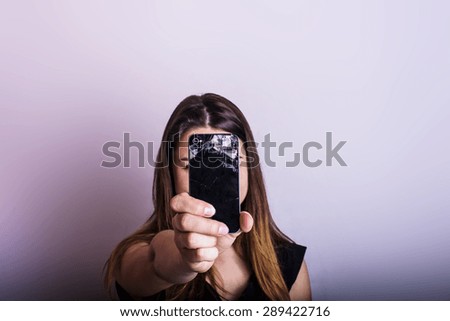 young caucasian female holding broken cellphone