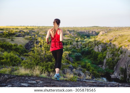 trail running in canyon. Young caucasian model running in beautiful rocky landscape/ female runner in canyon.