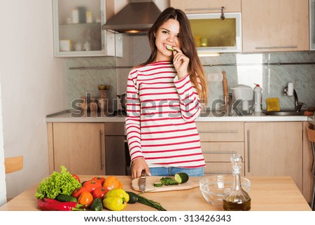 Young Woman Cooking Vegetable Salad.  Dieting Concept. Healthy food and Lifestyle. Cooking At Home.