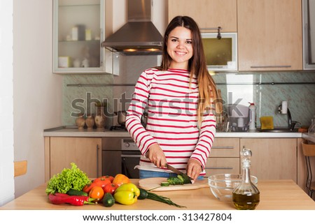 Young Woman Cooking Vegetable Salad.  Dieting Concept. Healthy food and Lifestyle. Cooking At Home.
