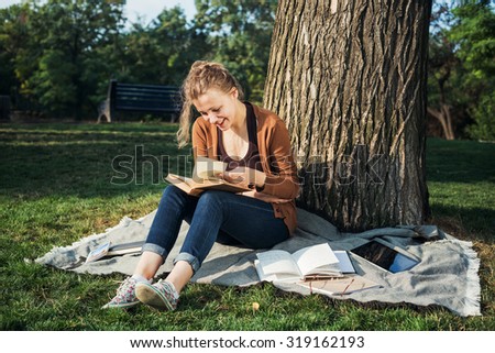 young caucasian female student with books on campus, student study in campus area