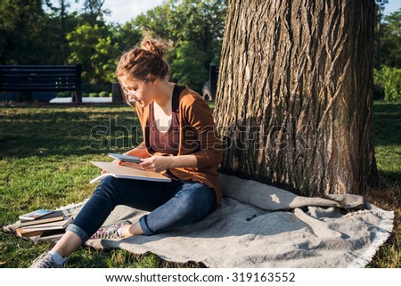 young caucasian female student with books on campus, student study in campus area