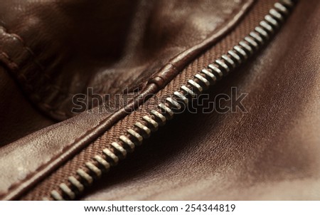Elegant brown jacket with zip detail. Close up photo.