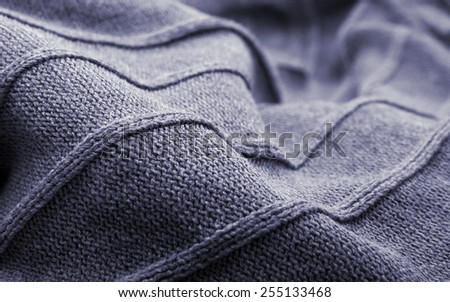 Close-up image of a cashmere pullover. Gray color, two tones.