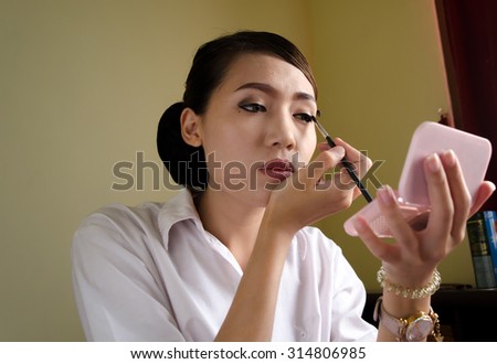 Asian woman make up in the room