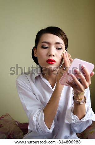 Asian woman make up in the room