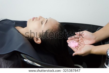 Woman wash hair in hair salon