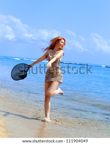 The girl jumps on an ocean coast