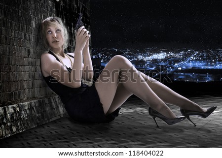 The young woman with the gun on a roof. Night.