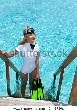 Young pretty woman with flippers, mask and tube.  Maldives