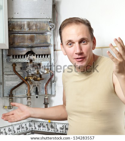 The man  thinks of repair of a gas water heater
