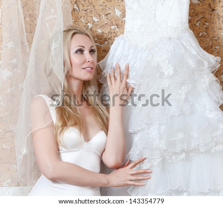 The beautiful woman, the bride, with a veil and a wedding dress