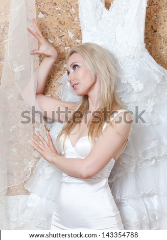 The beautiful woman, the bride, with a veil and a wedding dress