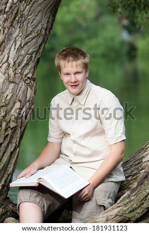 The young man (the pupil, the student) reads the book on the river bank