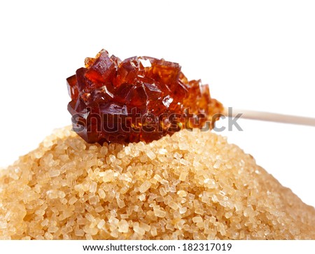 Brown candy sugar on a stick and brown sugar