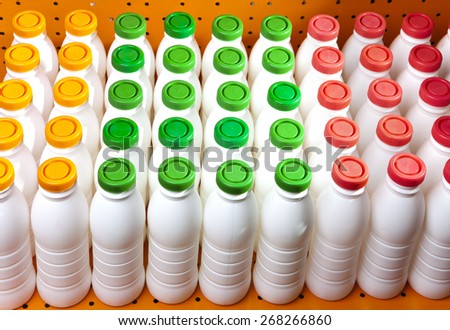 dairy products bottles with bright covers on a shelf in the shop