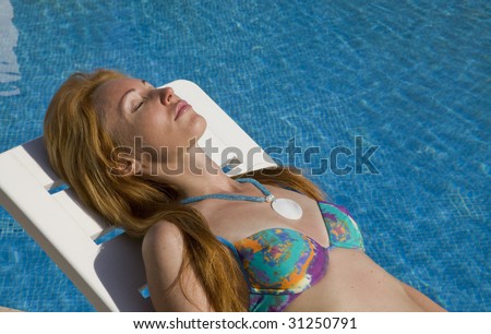 Woman smiles having a rest at pool