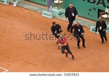 PARIS - JUNE 7: Infringer ran in on court with flag at French Open, Roland Garros on June 7, 2009 in Paris, France.