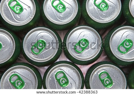 Aluminum cans in drops of water with keys close-up, focus on center